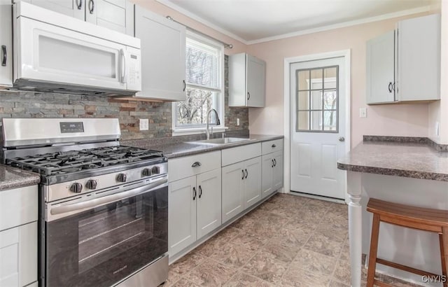 83 Salisbury St, Sandy Creek, NY 13083 - kitchen with stainless steel gas range, a sink, white microwave, backsplash, and ornamental molding