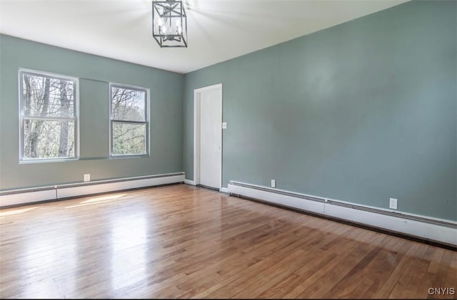 83 Salisbury St, Sandy Creek, NY 13083 - empty room with baseboards, wood finished floors, and a baseboard radiator
