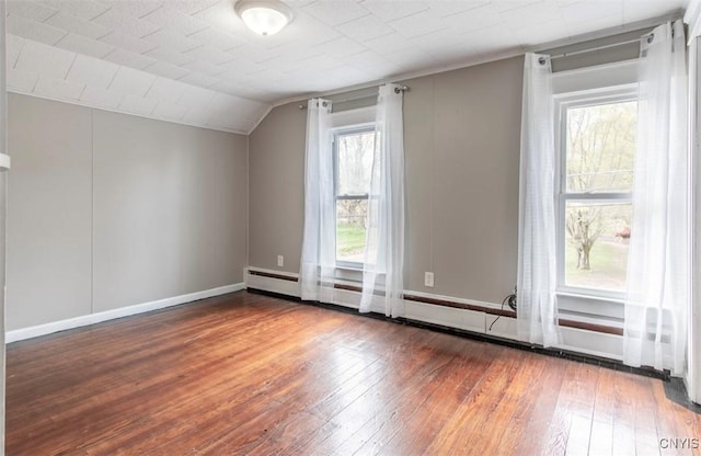 83 Salisbury St, Sandy Creek, NY 13083 - additional living space featuring vaulted ceiling, wood-type flooring, baseboards, and a baseboard heating unit
