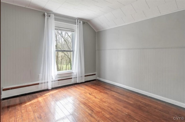 83 Salisbury St, Sandy Creek, NY 13083 - additional living space featuring lofted ceiling, wood finished floors, baseboards, and a baseboard heating unit