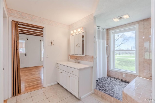 8733 State Route 289, Ellisburg, NY 13605 - full bath with a shower with curtain, visible vents, tile patterned flooring, vanity, and tasteful backsplash