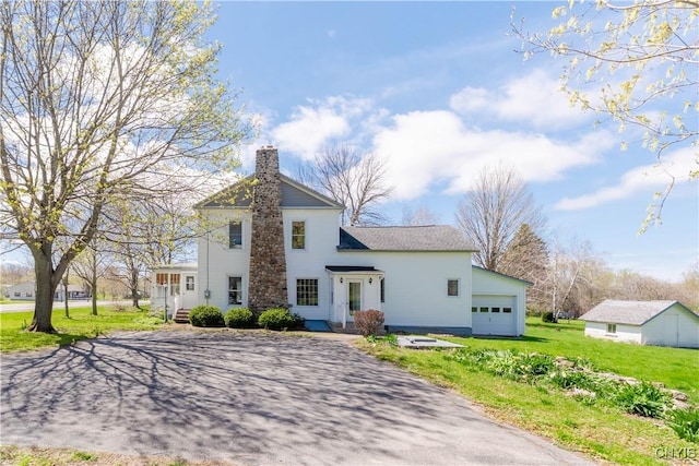 8733 State Route 289, Ellisburg, NY 13605 - view of front of house with a garage, a front lawn, a chimney, and driveway