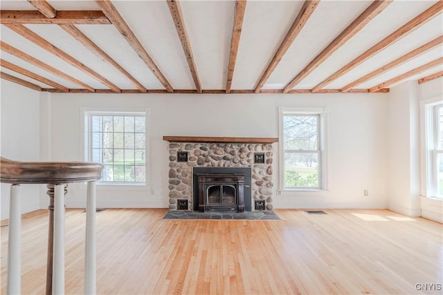8733 State Route 289, Ellisburg, NY 13605 - unfurnished living room featuring visible vents, beamed ceiling, plenty of natural light, and wood finished floors