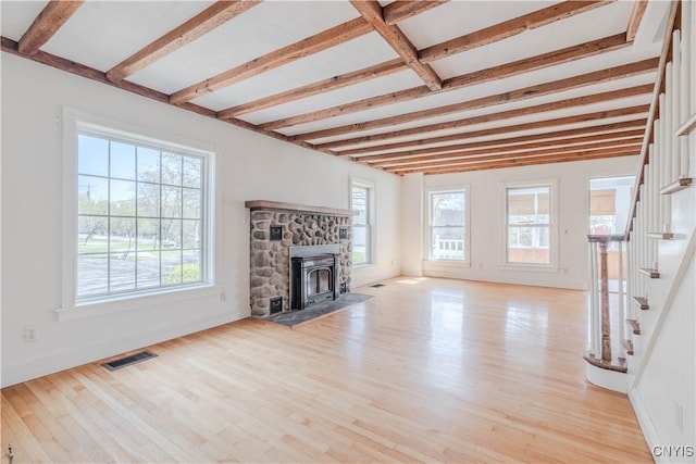8733 State Route 289, Ellisburg, NY 13605 - unfurnished living room with beamed ceiling, stairway, light wood finished floors, and visible vents
