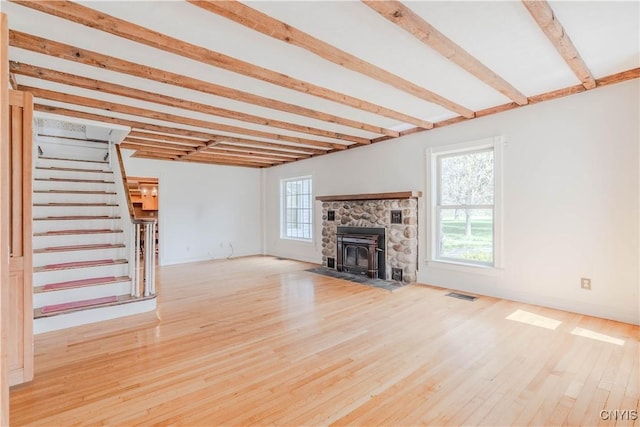 8733 State Route 289, Ellisburg, NY 13605 - unfurnished living room with beam ceiling, visible vents, wood finished floors, and stairs