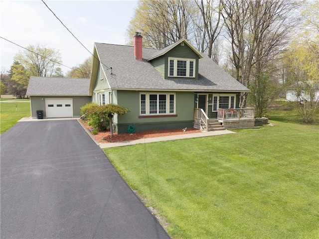 view of front of property featuring covered porch, a chimney, a shingled roof, a front yard, and driveway