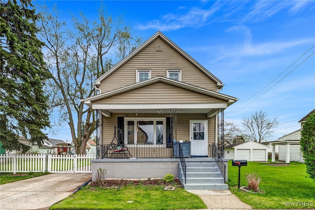 69 Franklin Ave, Cheektowaga, NY 14212 - view of front of home with covered porch, fence, a front lawn, and an outdoor structure