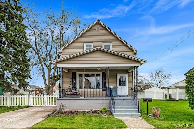 69 Franklin Ave, Cheektowaga, NY 14212 - view of front of home with covered porch, fence, a front lawn, and an outdoor structure