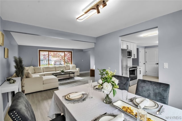 dining area with light wood finished floors