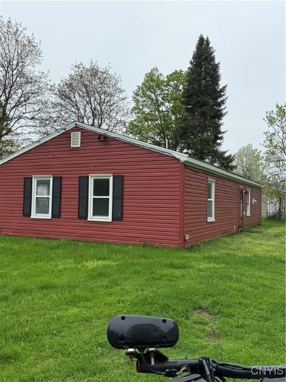 view of home's exterior with a yard