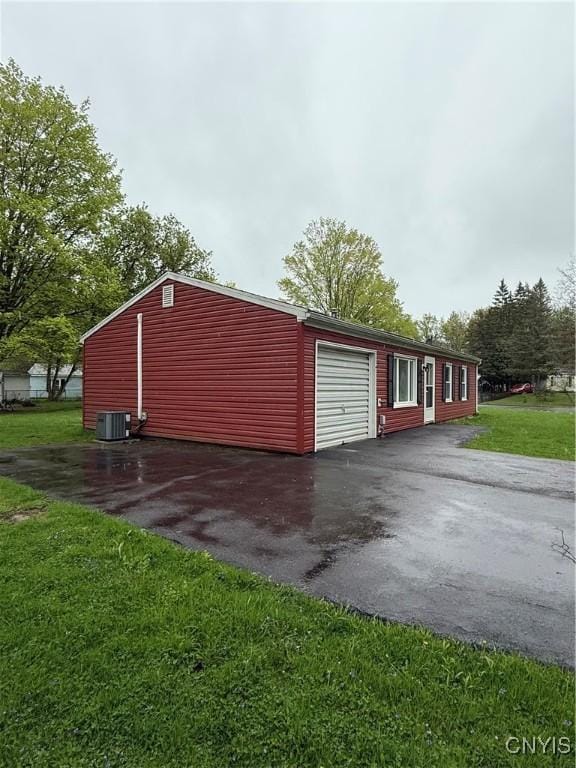 exterior space with cooling unit and driveway