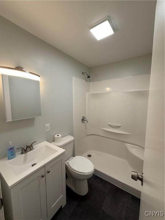 full bath featuring vanity, toilet, a shower, and tile patterned floors