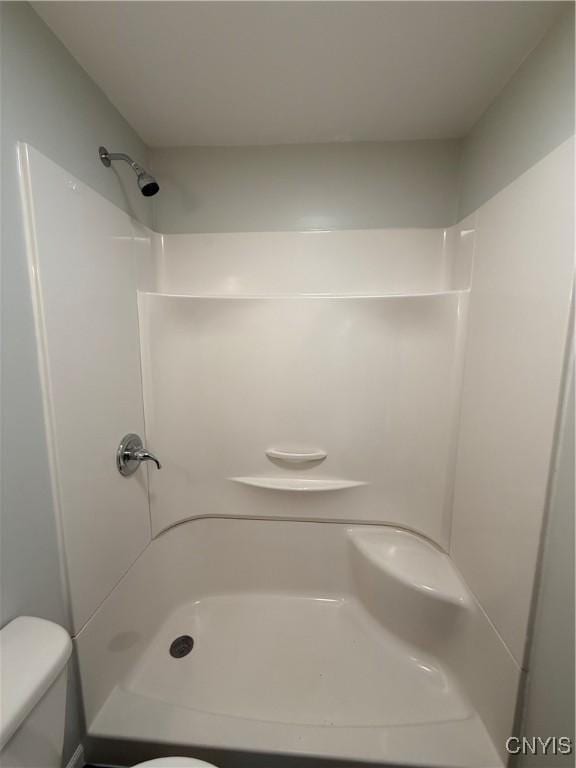 bathroom with toilet and a shower
