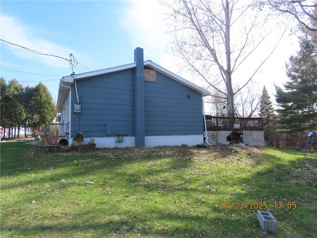 6937 State Highway 56, Potsdam, NY 13676 - view of side of home with a yard, a deck, a playground, and a chimney
