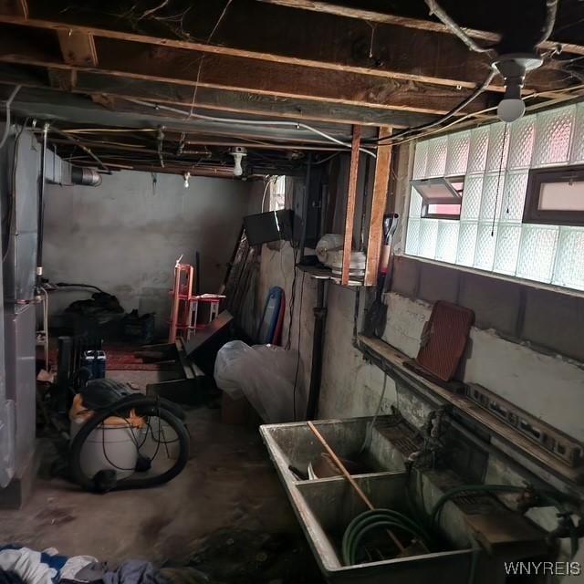 basement with a ceiling fan