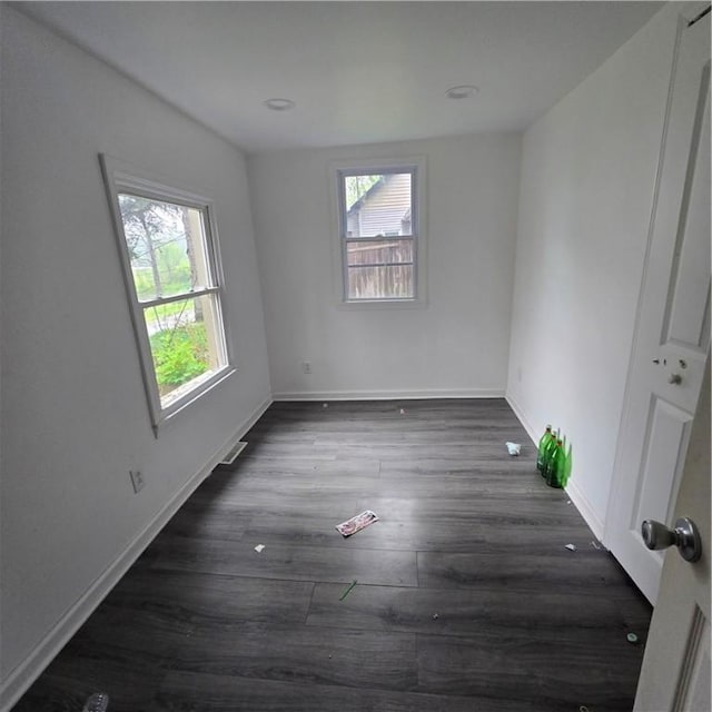 1570 Pennsylvania Ave, Southport, NY 14871 - unfurnished room featuring dark wood finished floors, plenty of natural light, and baseboards