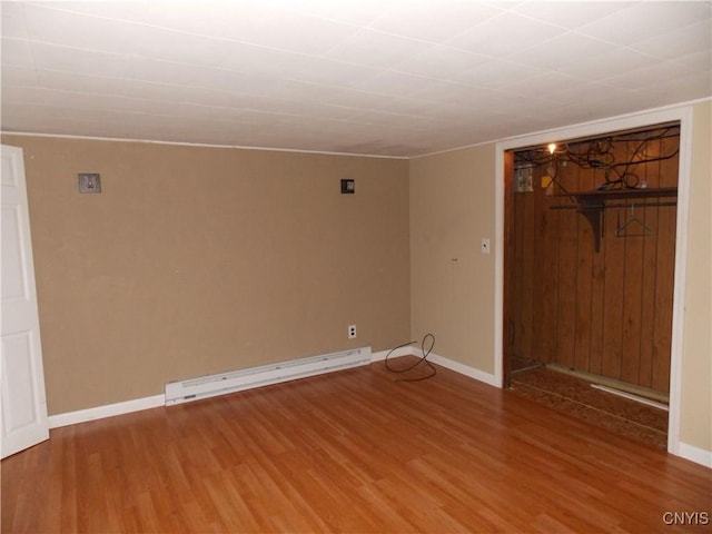 26105 State Route 3, Le Ray, NY 13601 - empty room with wood finished floors, baseboards, and a baseboard heating unit