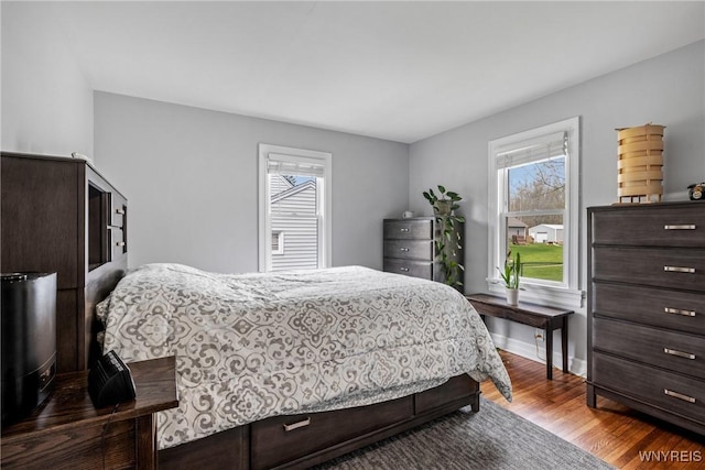 bedroom with baseboards and dark wood-style floors
