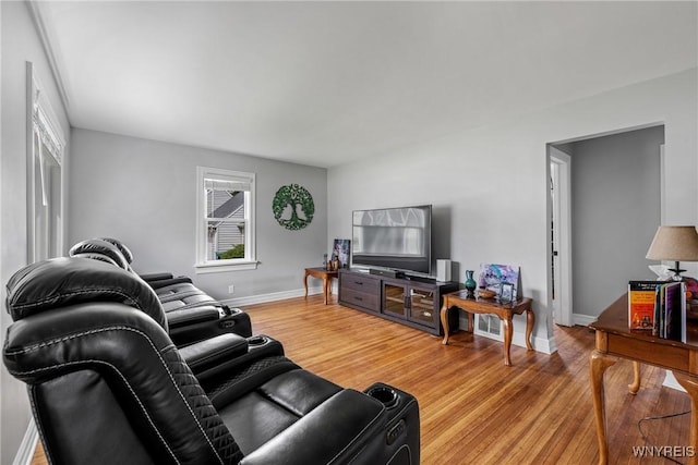 living room featuring light wood finished floors and baseboards
