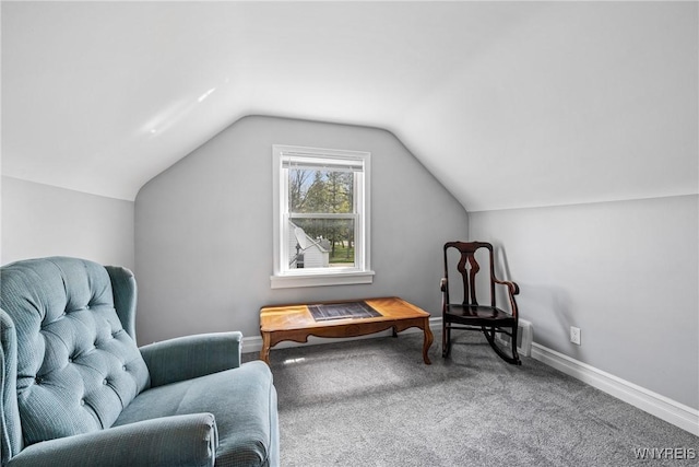living area with lofted ceiling, carpet, and baseboards