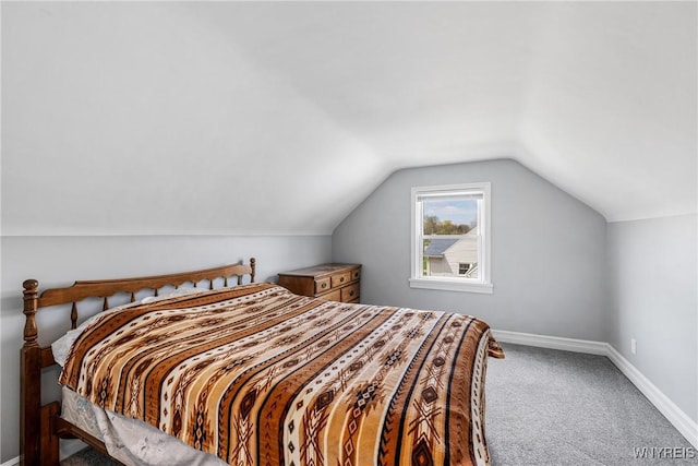 bedroom featuring lofted ceiling, carpet flooring, and baseboards