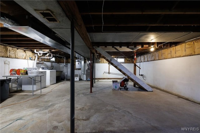 unfinished basement with washer and dryer and visible vents