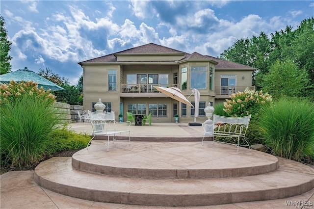 back of house featuring a patio and a balcony
