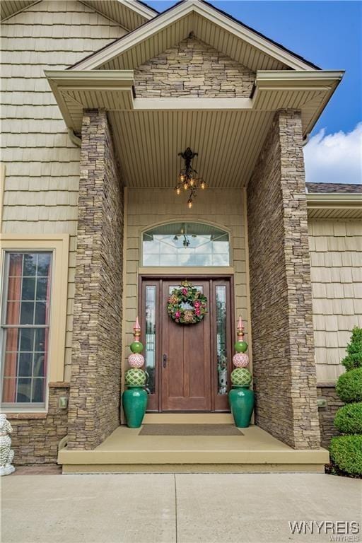 entrance to property featuring stone siding