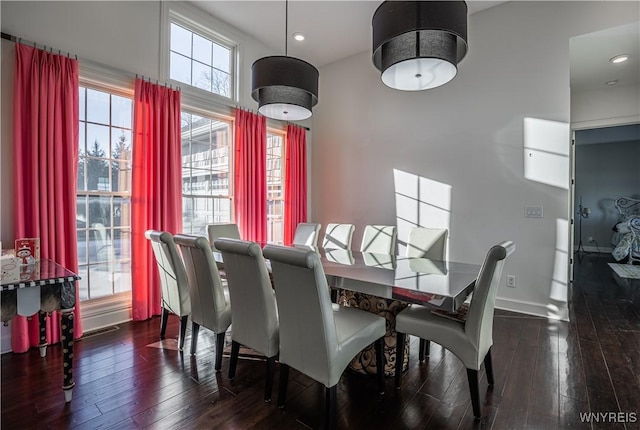 dining area with baseboards, hardwood / wood-style floors, and recessed lighting