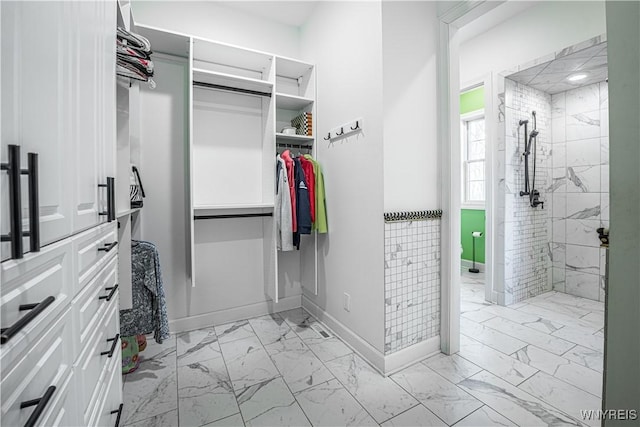 spacious closet featuring marble finish floor