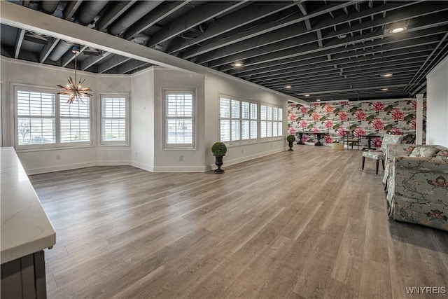 unfurnished living room with baseboards and wood finished floors