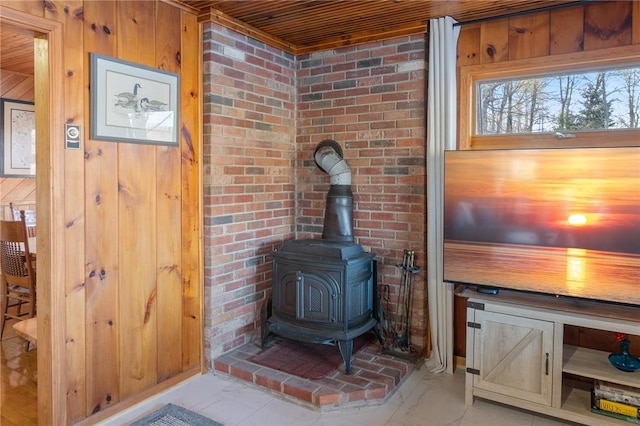 interior details featuring a wood stove and wood walls