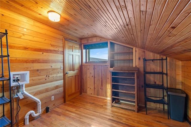 bonus room featuring wooden ceiling, lofted ceiling, wooden walls, and light wood-style floors