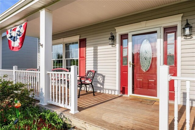 view of exterior entry featuring a porch