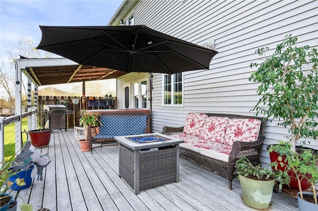 deck with a fire pit and area for grilling