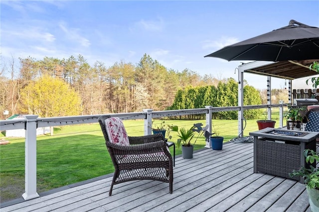 deck with a fire pit and a yard