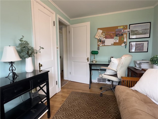 home office featuring ornamental molding, visible vents, and wood finished floors