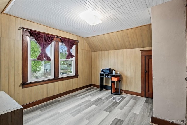 additional living space featuring wooden ceiling, light wood finished floors, lofted ceiling, and wooden walls