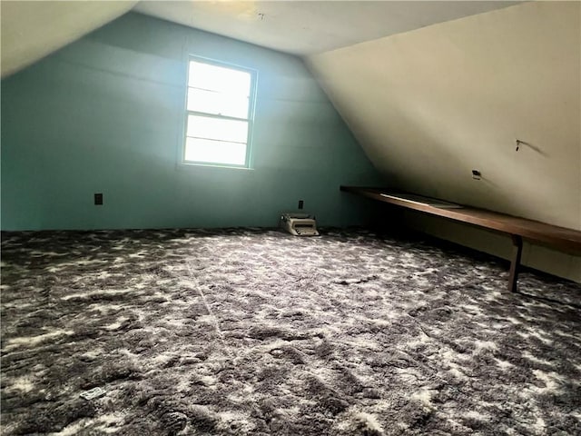 bonus room featuring lofted ceiling and carpet flooring