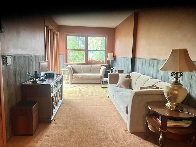 carpeted living area featuring wainscoting