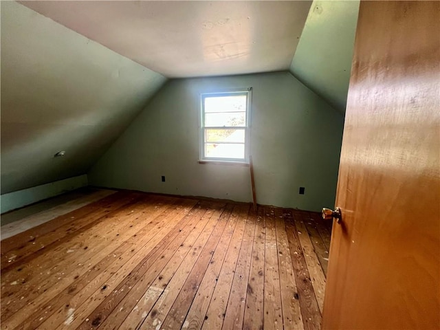 bonus room with lofted ceiling and wood-type flooring