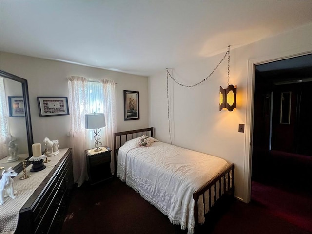 bedroom featuring dark carpet