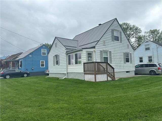 exterior space with a lawn, metal roof, and a standing seam roof