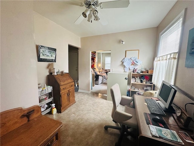 office area with light colored carpet, a wealth of natural light, and a ceiling fan