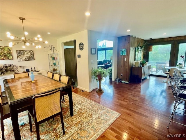 dining room featuring wood finished floors, visible vents, baseboards, a chandelier, and recessed lighting