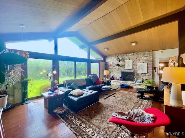 living area with a fireplace, hardwood / wood-style flooring, and lofted ceiling with beams