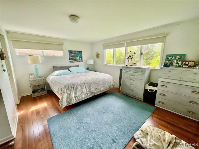 bedroom featuring wood finished floors and baseboards