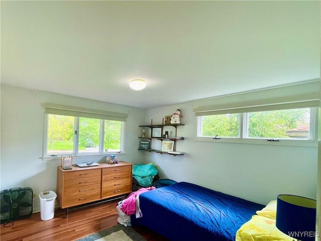 bedroom with dark wood finished floors