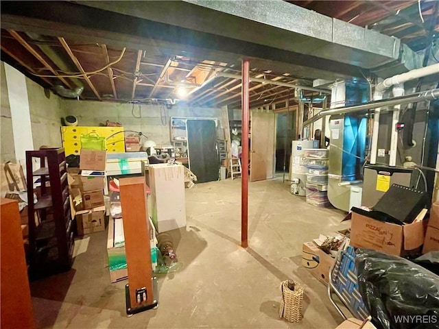unfinished below grade area with heating unit and gas water heater