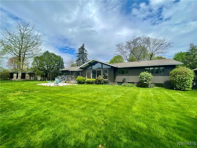 back of house with a yard, a patio, and fence
